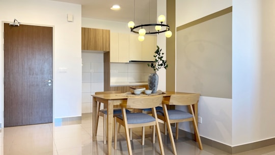 A dining room with wood furniture and minimalist decor.