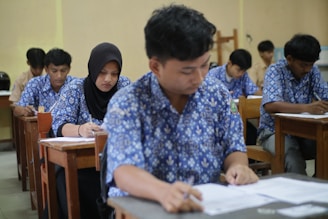 Students are taking a test in a classroom.