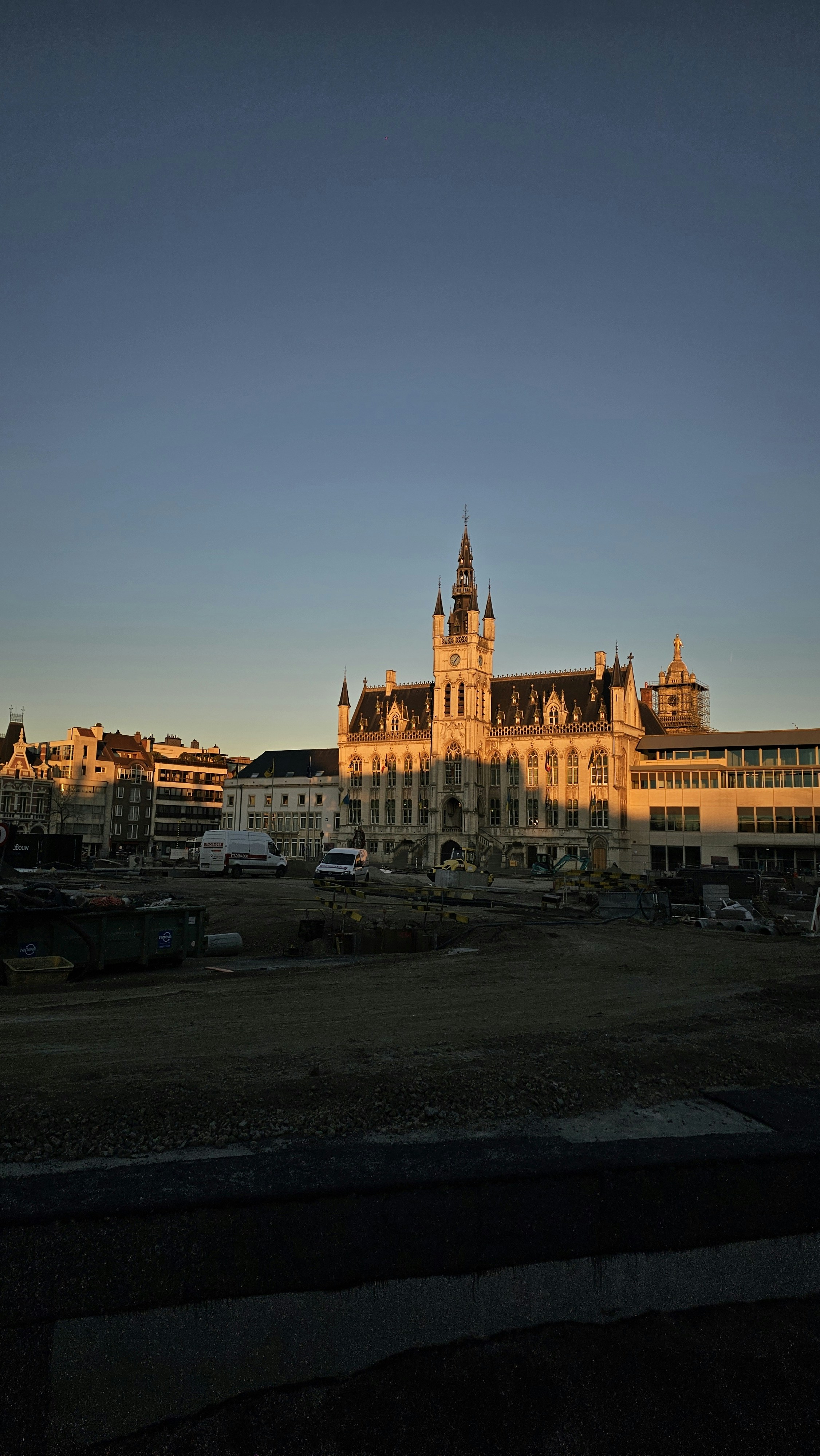 Golden hour sunlight bathes a grand building.