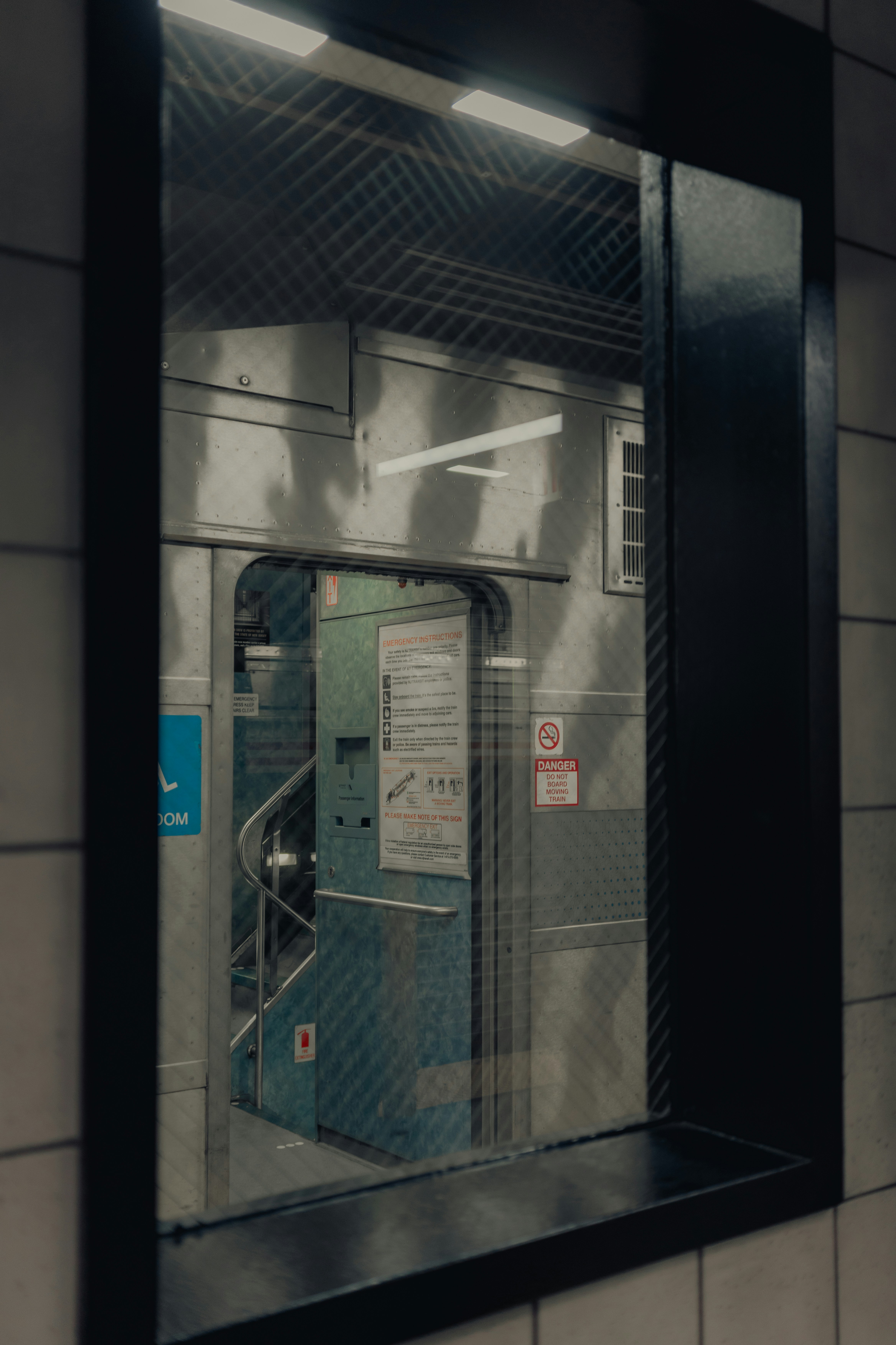 Subway entrance behind a window with a closed door.