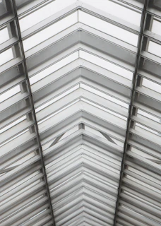 Geometric roof and window structure overhead.