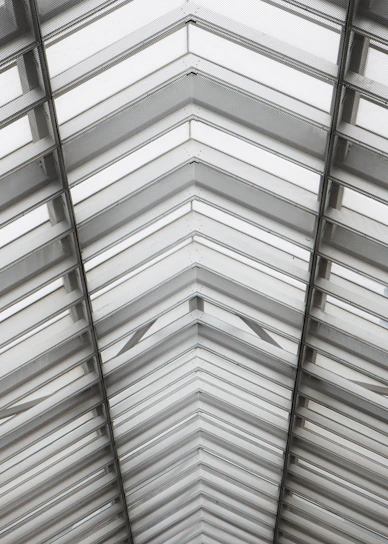 Geometric roof and window structure overhead.