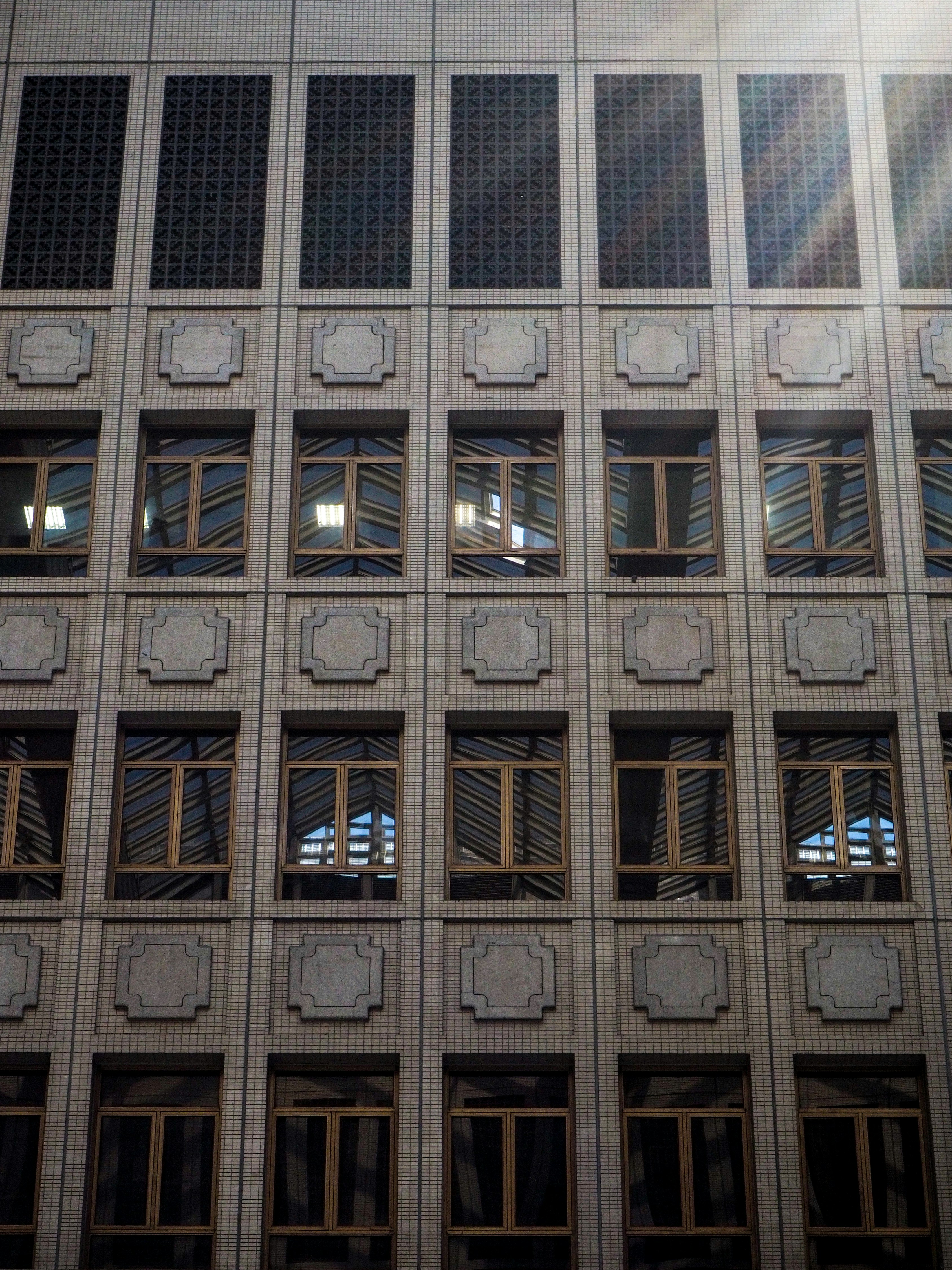 A modern building's facade with windows. photo – Free Building Image on ...