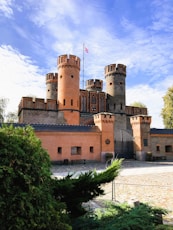 A beautiful castle with a cloudy sky in the background.