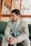 Man in suit sitting and looking away.
