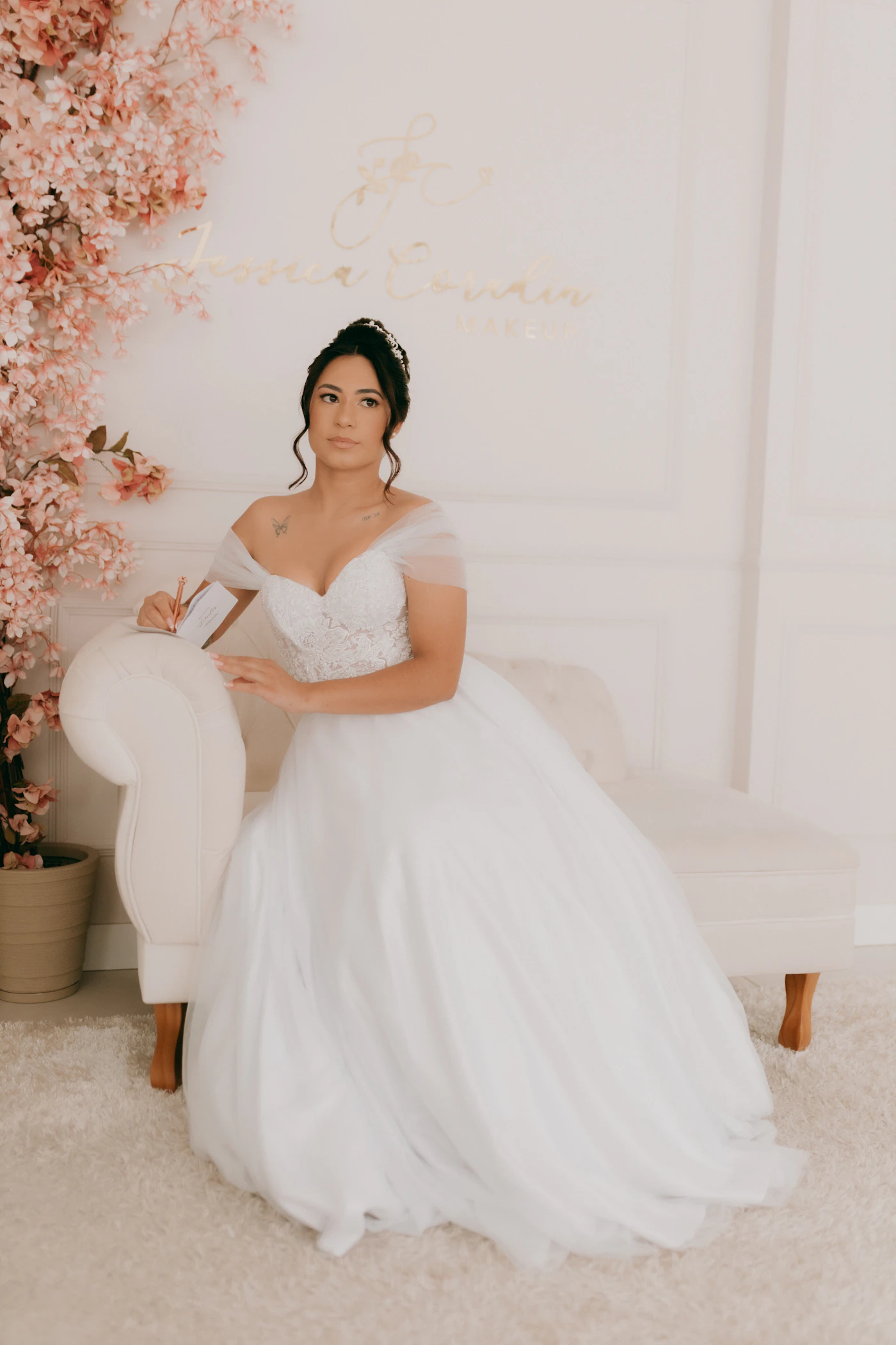 Inclusive size charts for bridal boutiques near me — A bridal consultant helping a bride into a sample dress