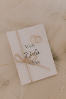 Wedding rings rest on a vow book.