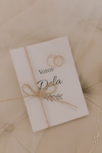 Wedding rings rest on a vow book.