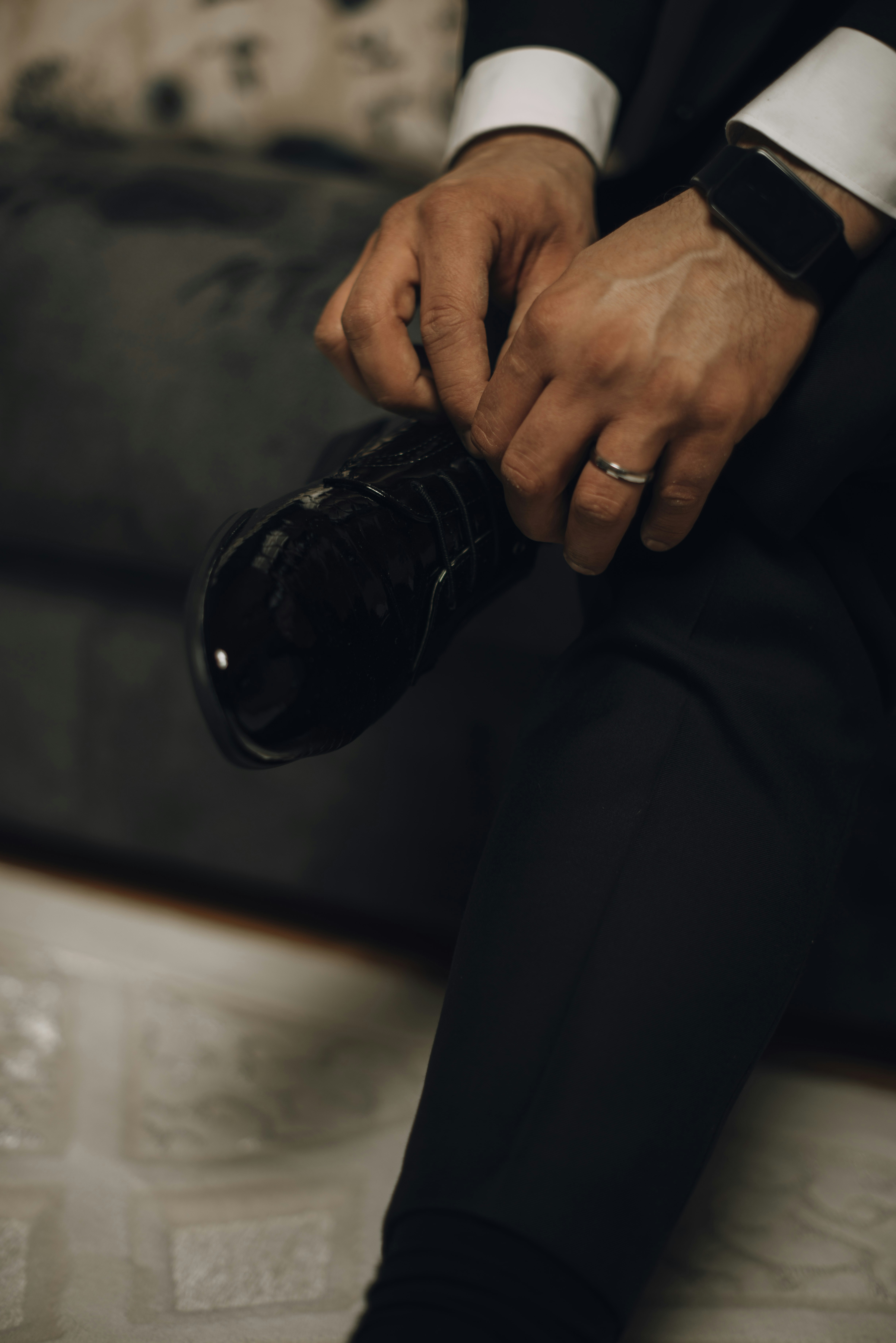 Man tying his shoe before an event.