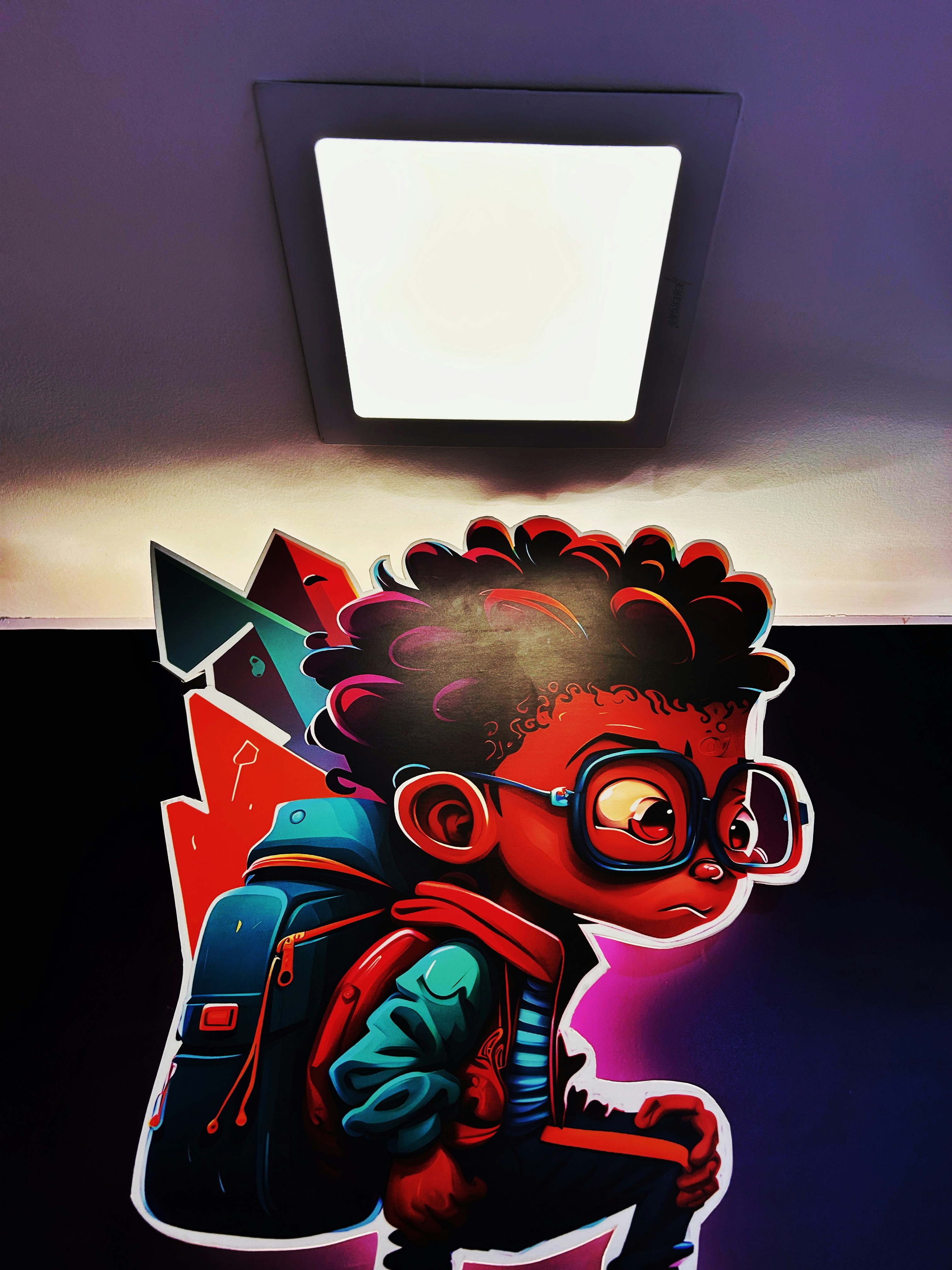 A cartoon boy standing under a bright spotlight