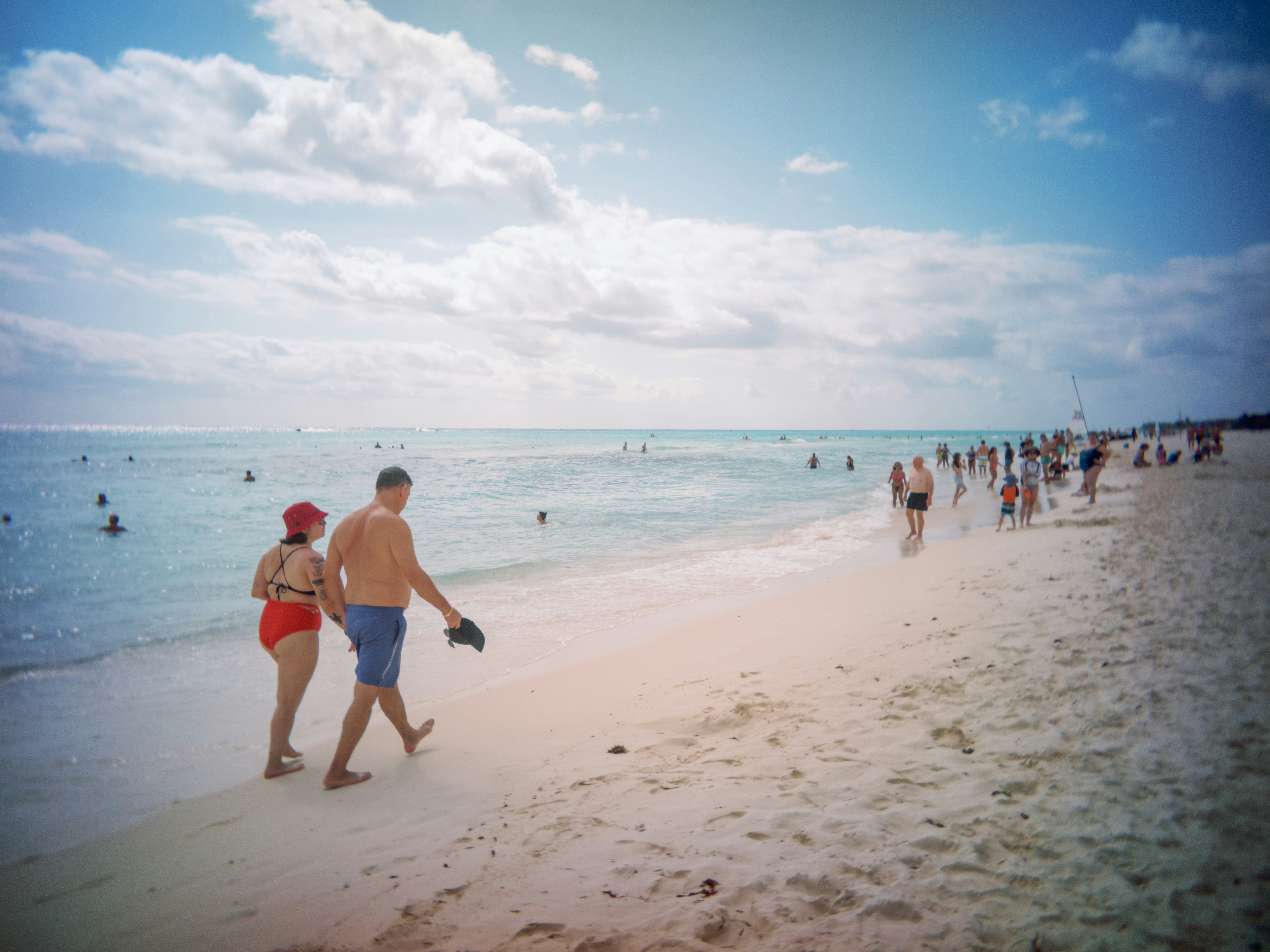 People enjoy a sunny day at the beach.