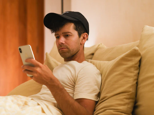 A man is focused on his phone.