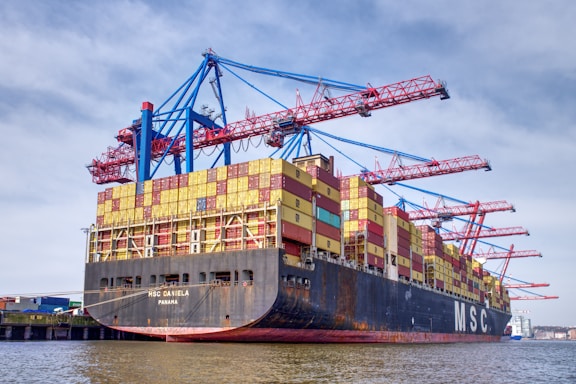 Cargo ship being loaded with containers at a port.