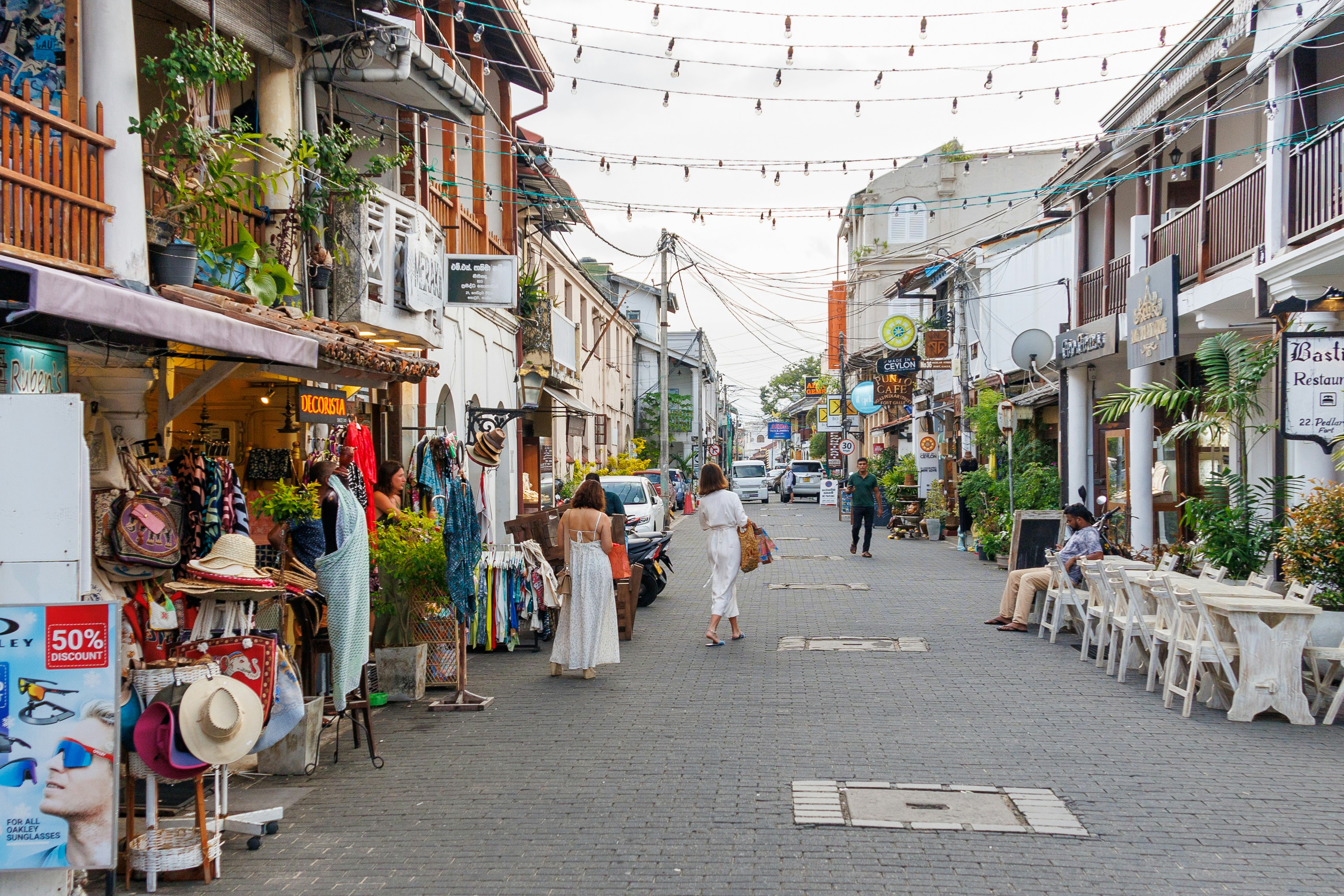 A beautiful street with shops and people., 