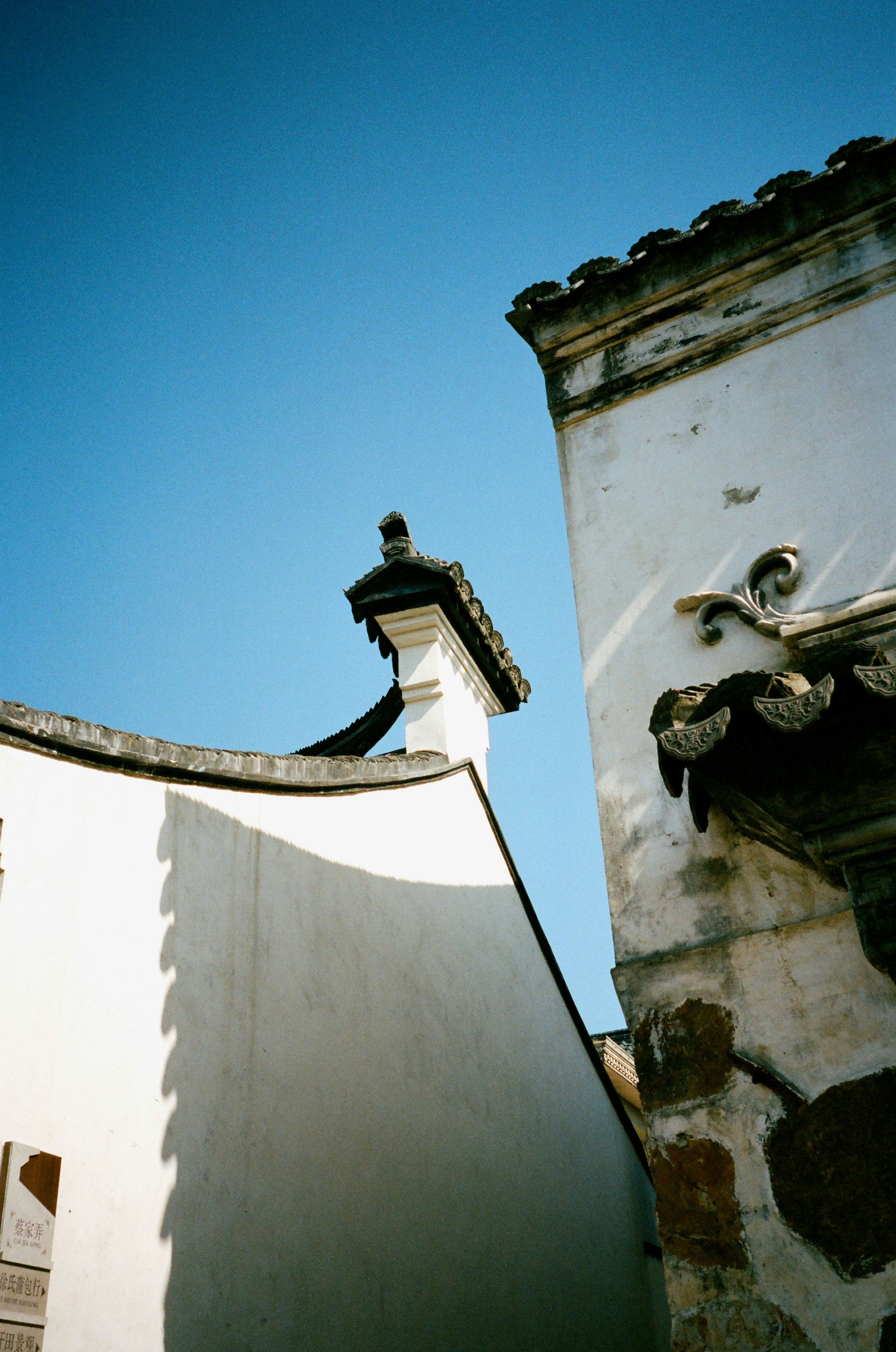 Chinese architecture against a vibrant blue sky.
