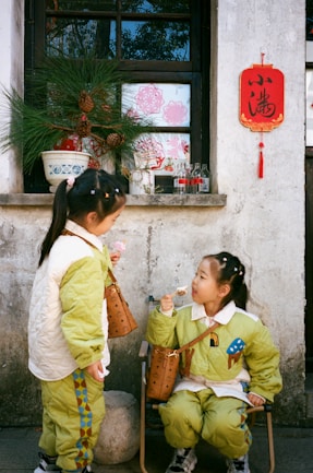 Two little girls enjoy ice cream together.