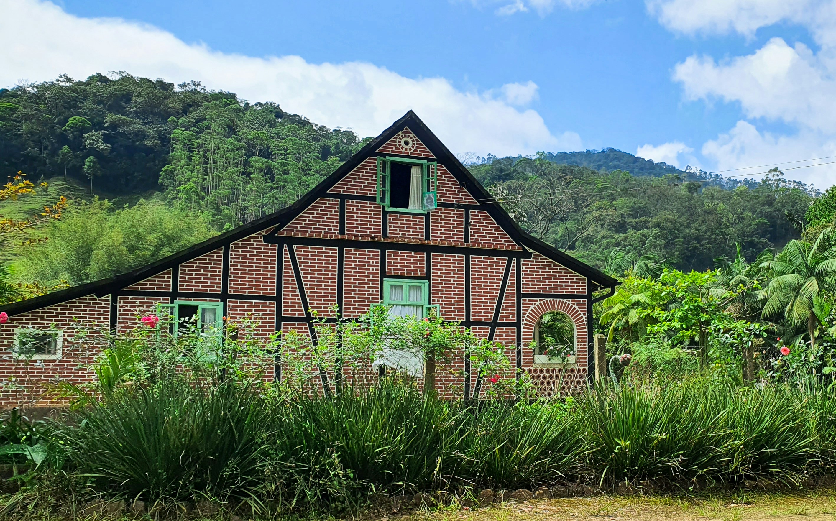 A charming house stands in a lush landscape.