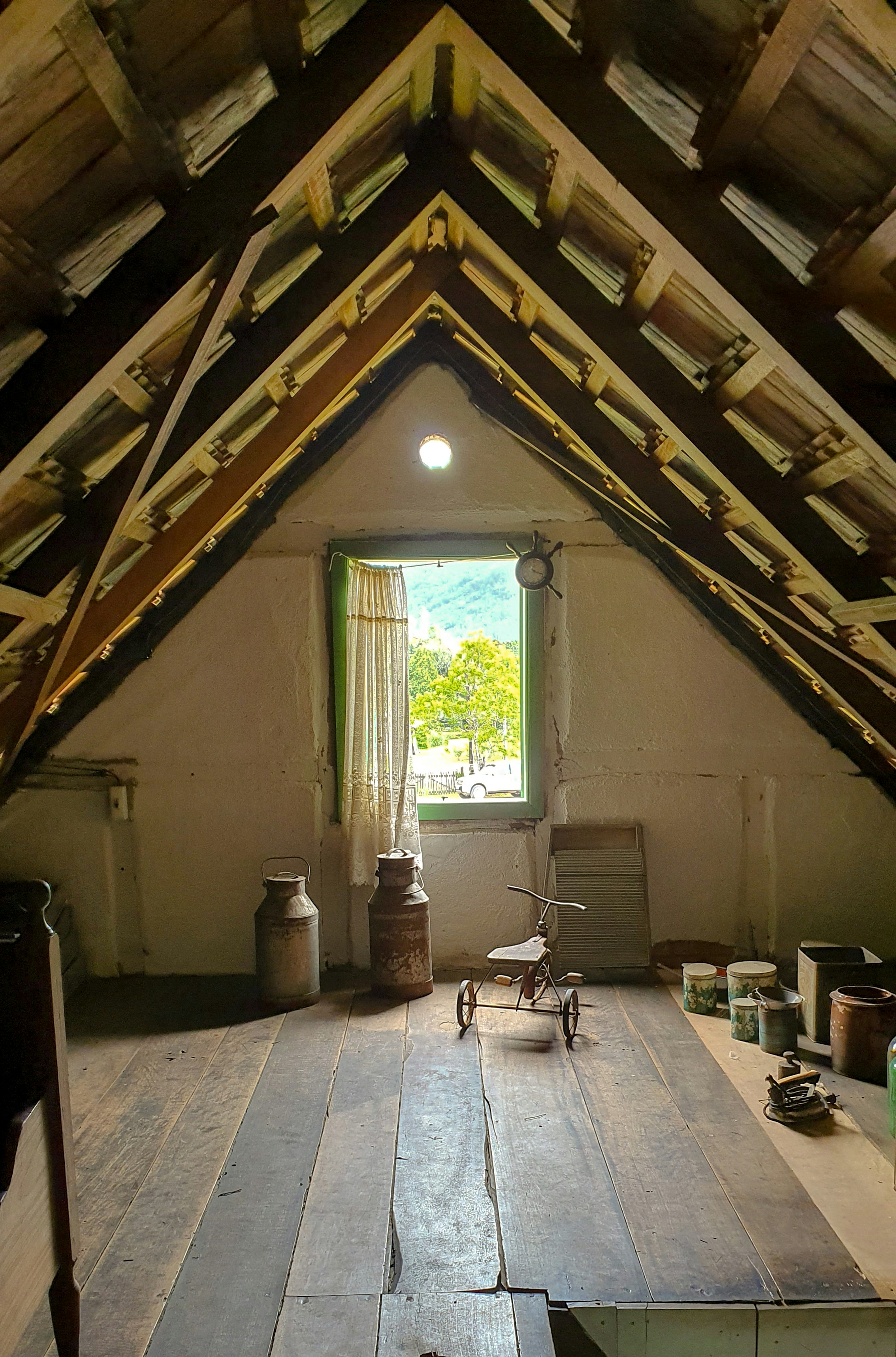 An attic room with a view and old items.