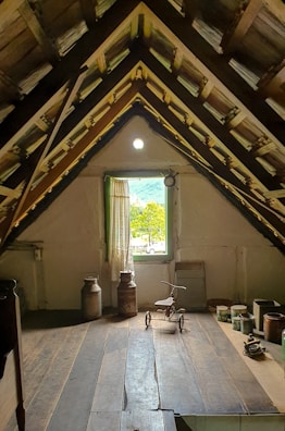 An attic room with a view and old items.
