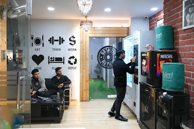 A gym interior with patrons and vending machines.