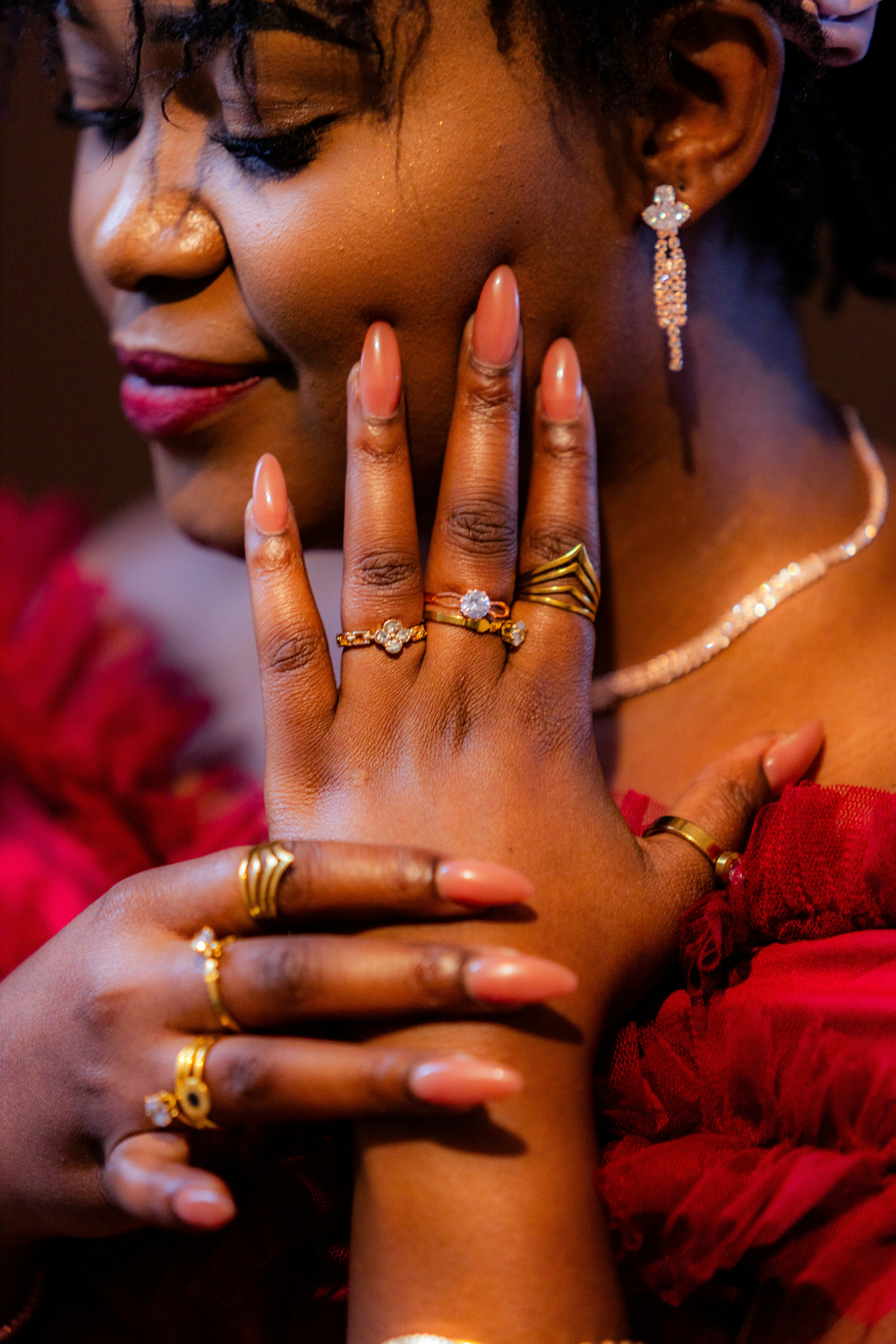Woman shows off several rings on her hands.