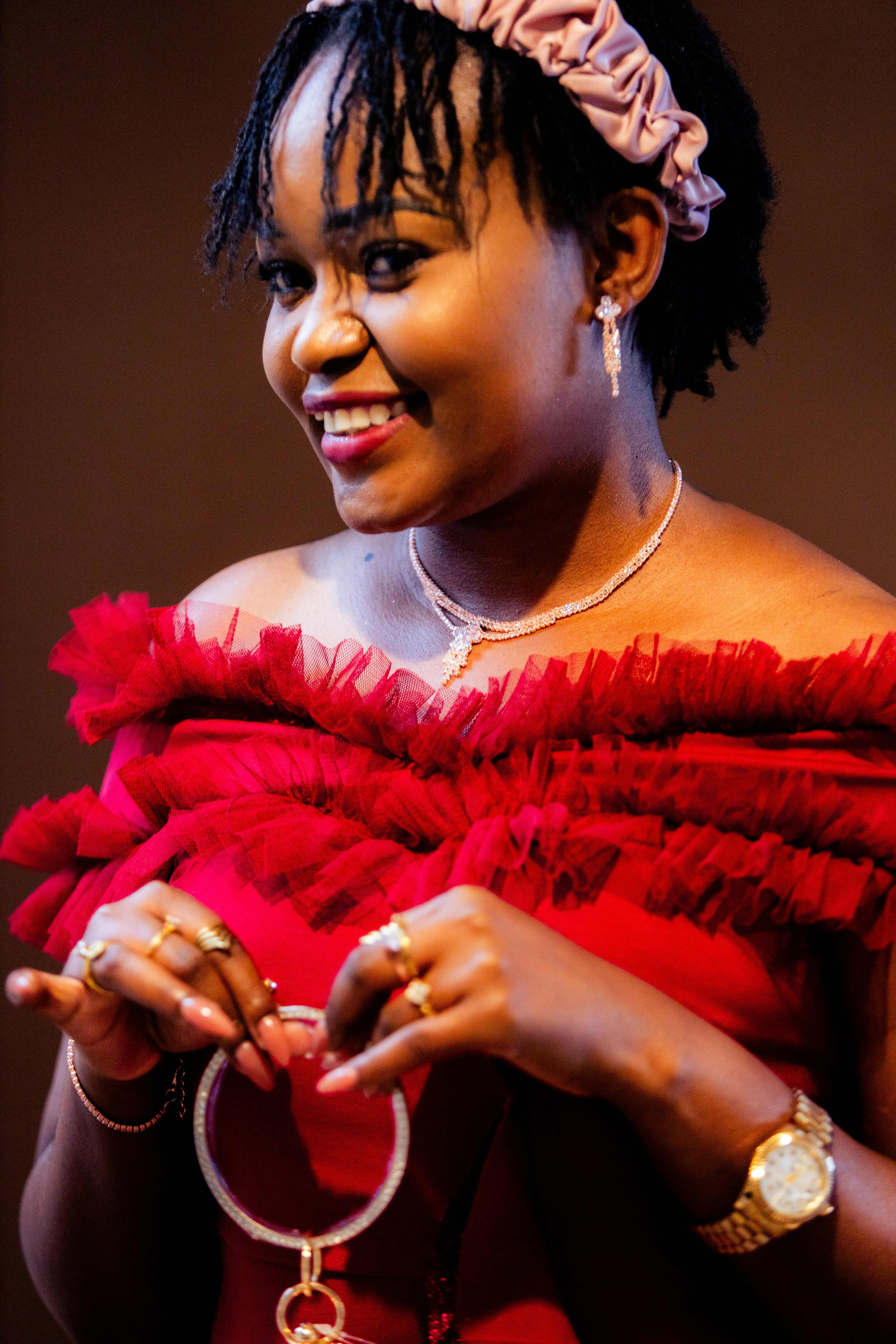Beautiful woman smiles and poses in a red dress.