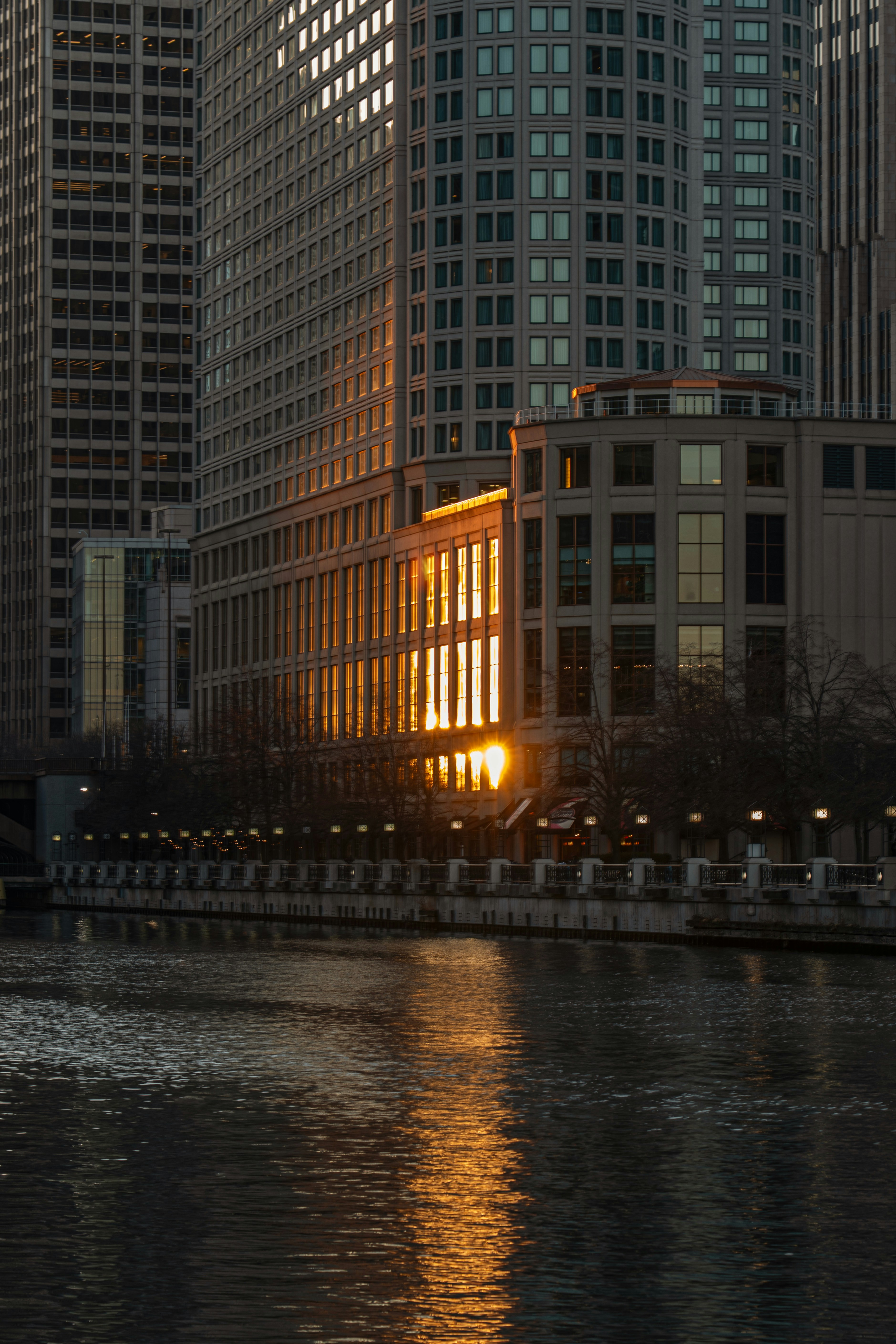 Sunlight illuminates a building by the water.