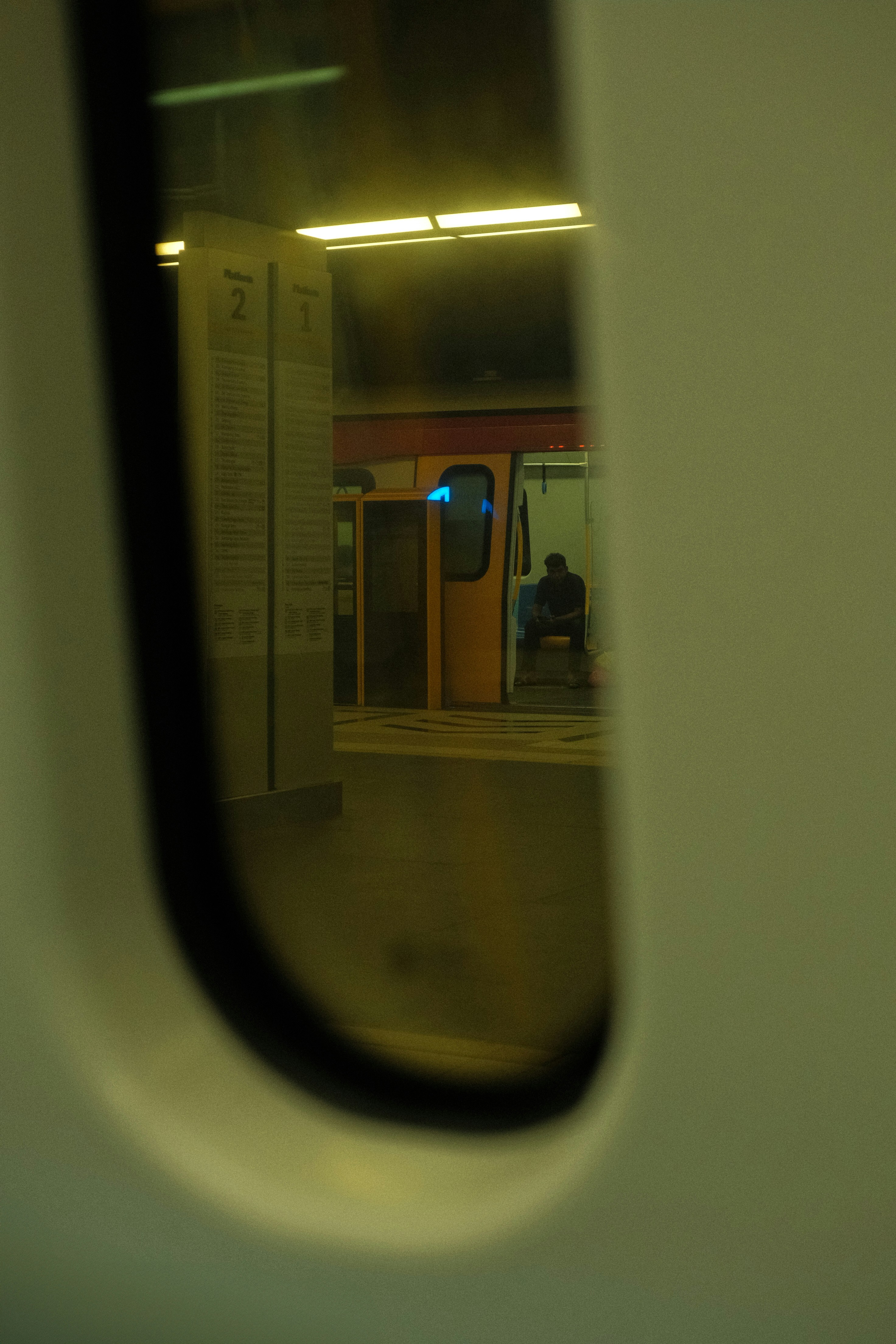 A person is waiting inside a metro station.