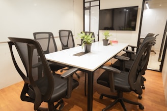 A modern, empty meeting room with furniture.