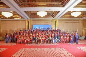 Graduation ceremony with many happy graduates.