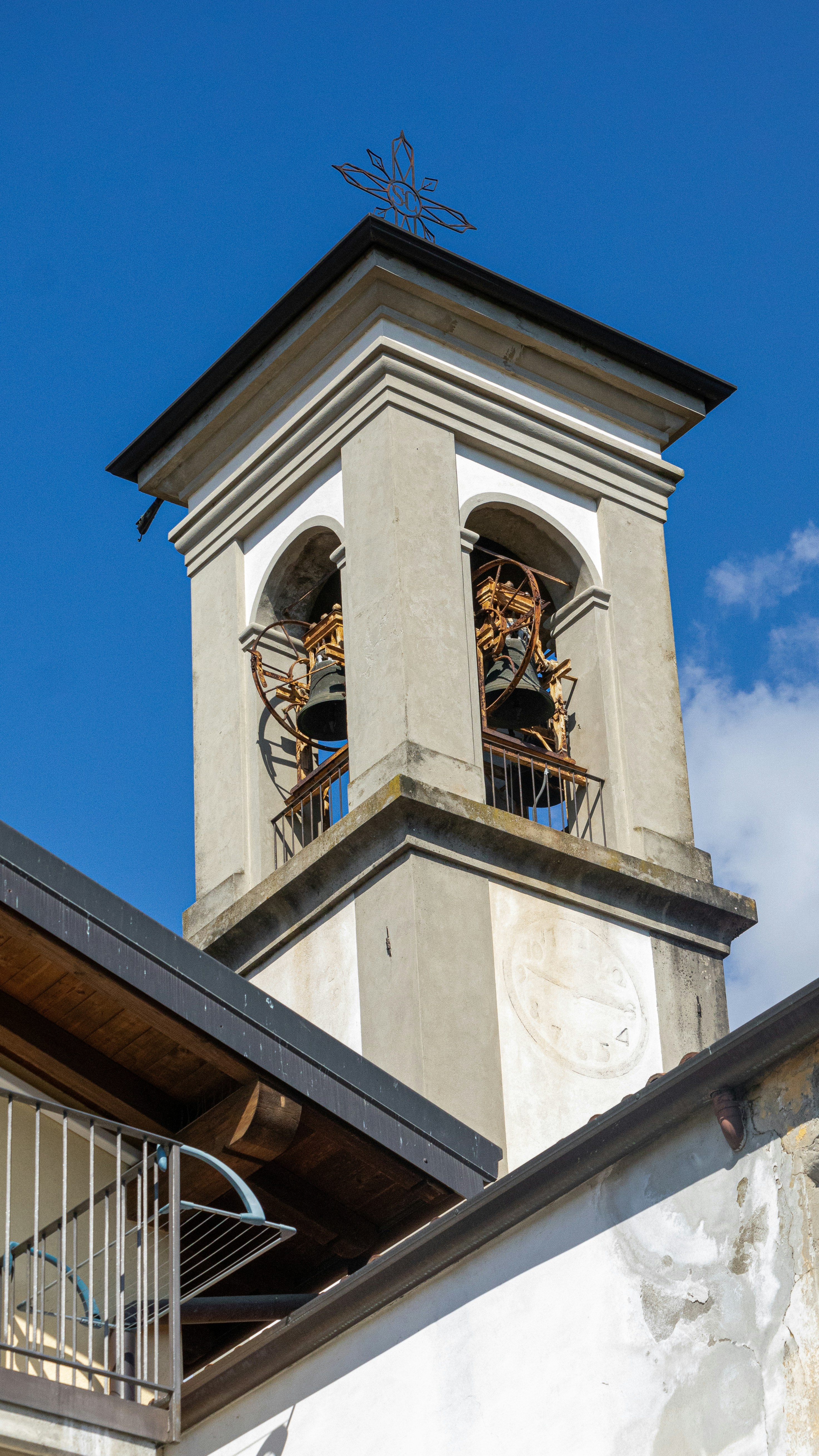 Church bell tower against a bright, blue sky.