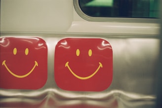 Smiling faces adorn red squares.