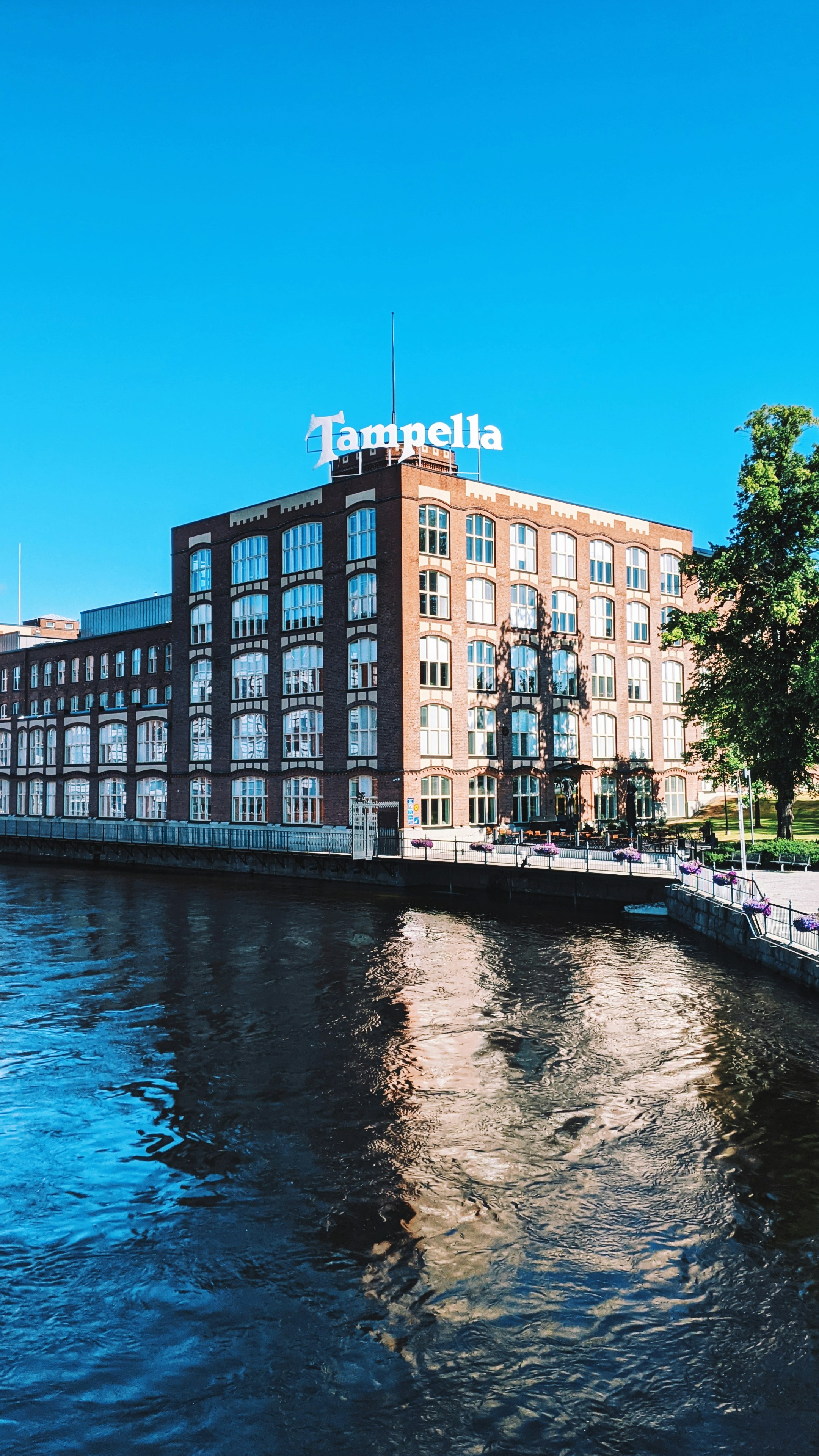 A building with the tampella sign next to the water.
