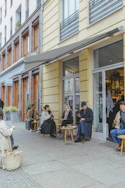 People are sitting outside a cafe.