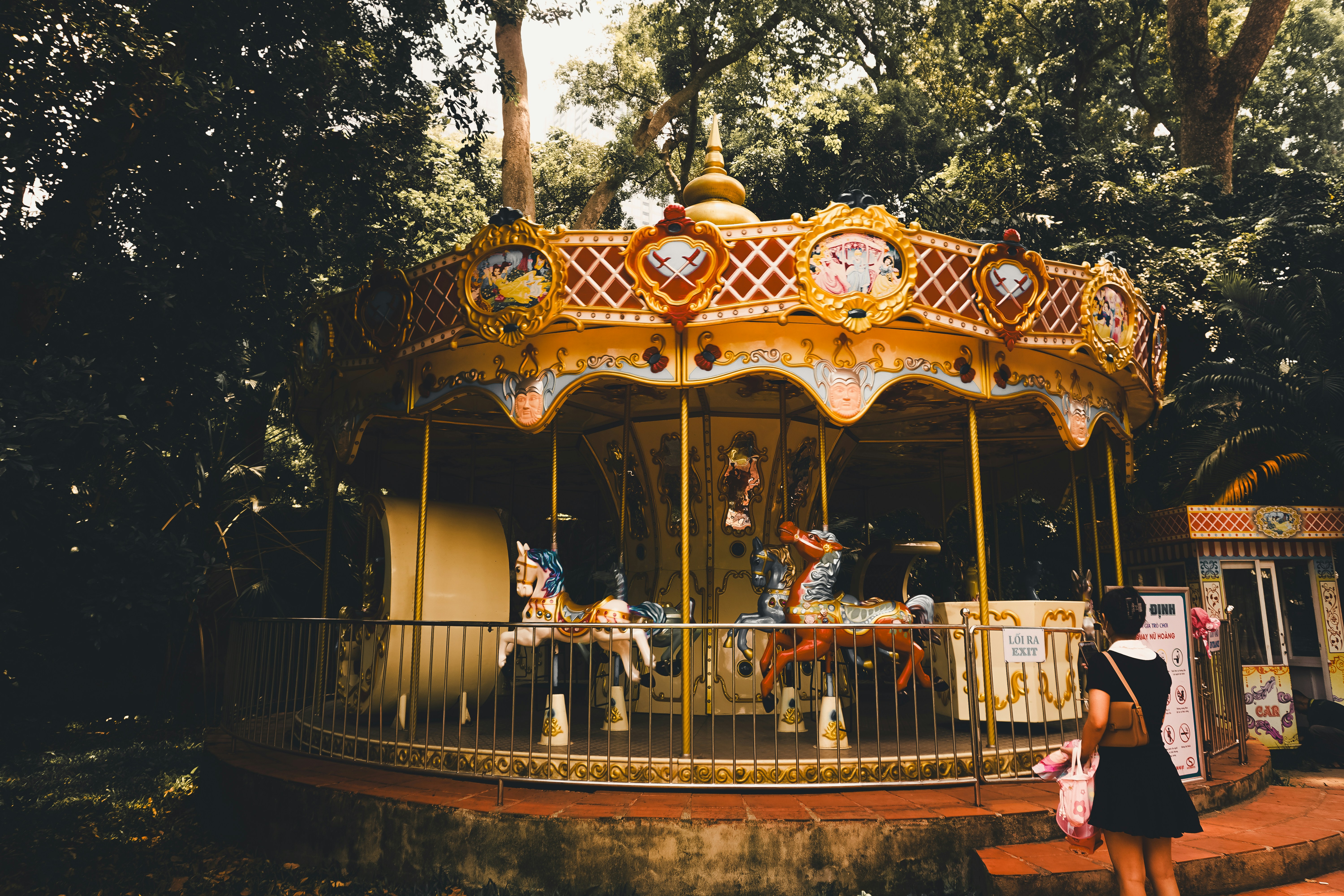 A beautiful carousel sits among trees.