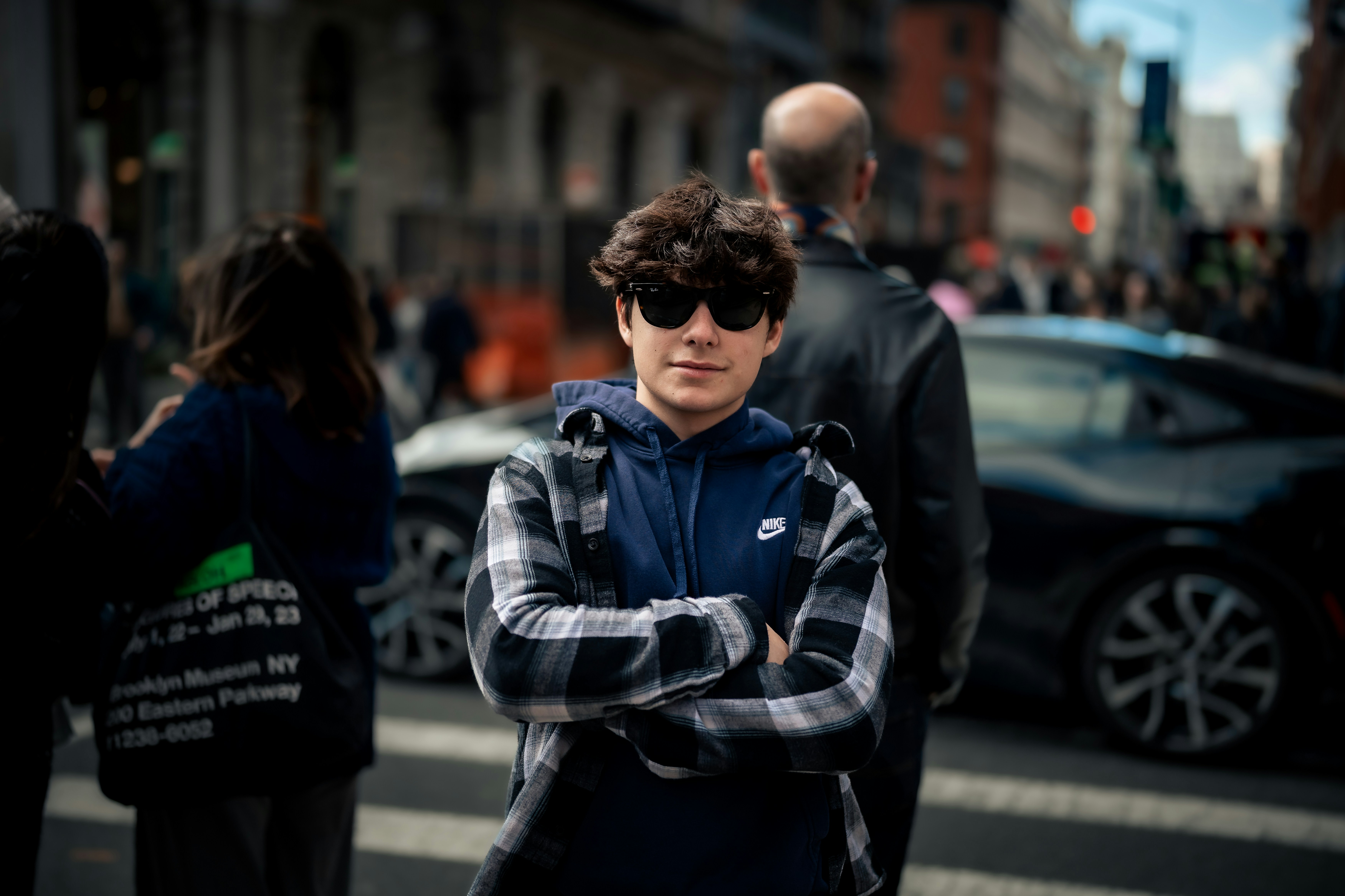 A young man poses on a busy city street. photo – Free Blue Image on ...
