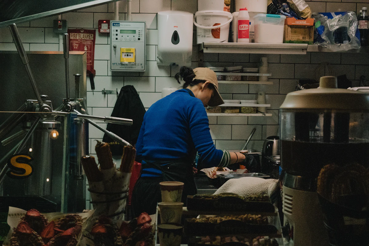 Restaurant owner working behind the counter during service