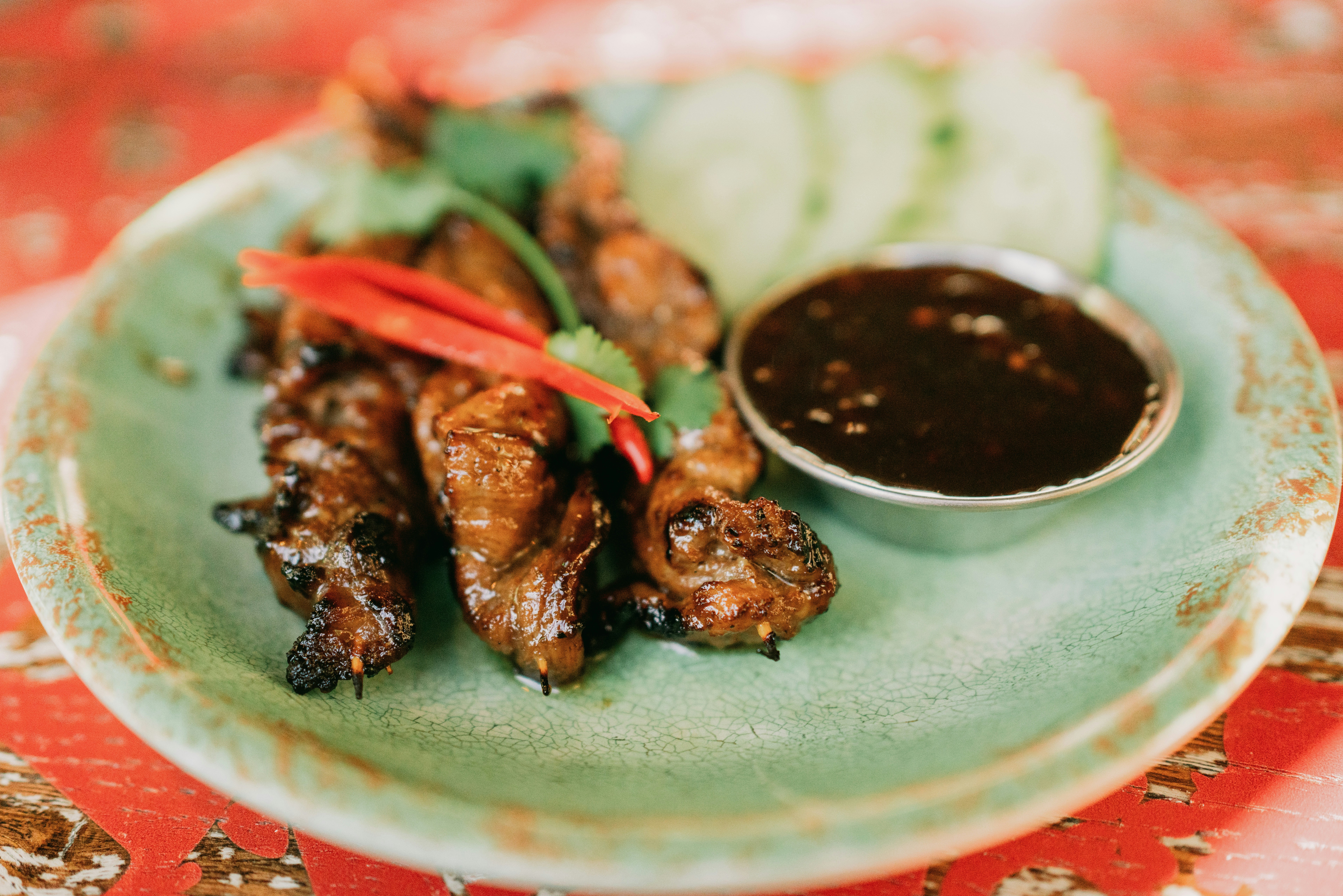 Delicious grilled meat skewers with dipping sauce., Thai food on a plate
