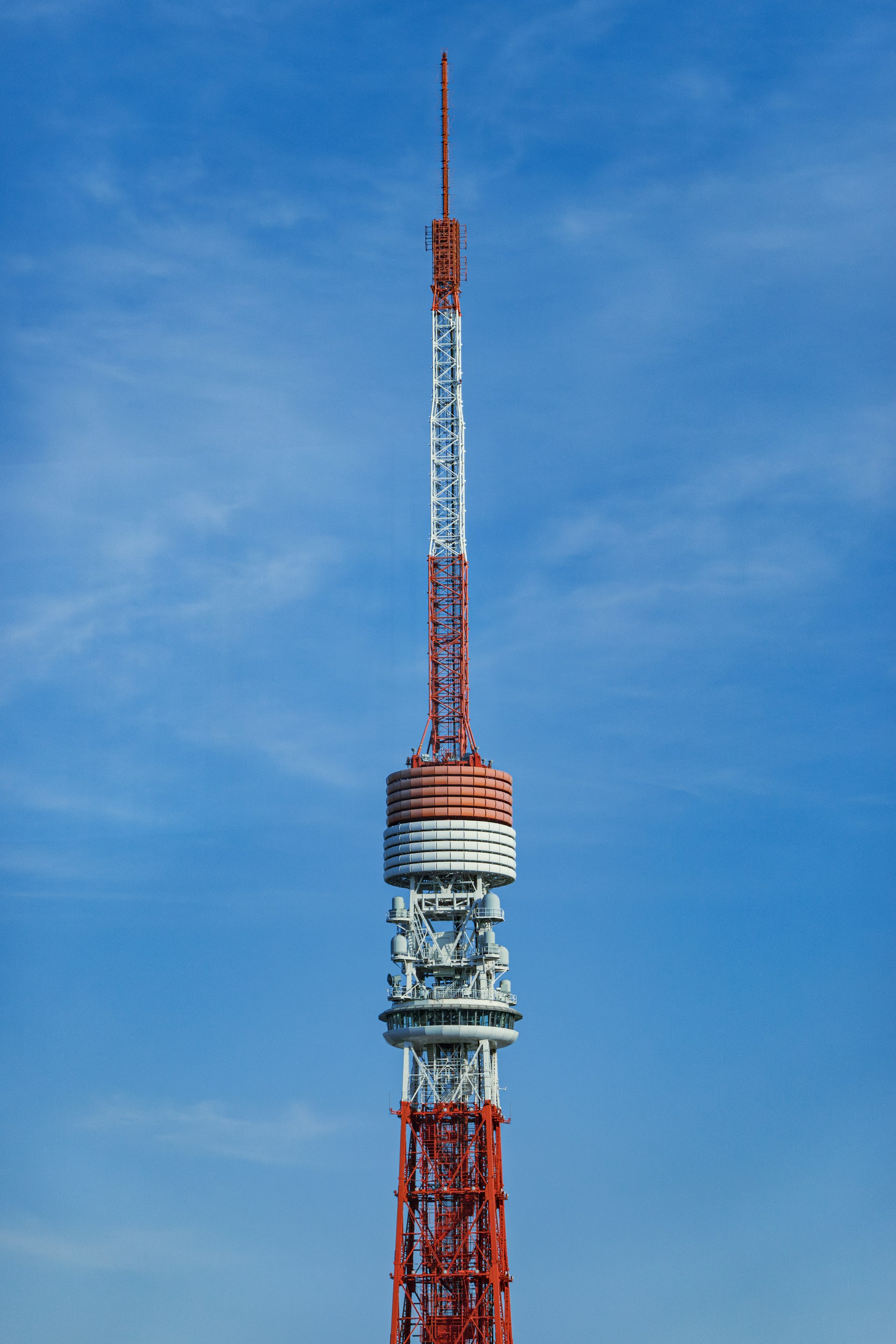 A tall tower stands against a blue sky.
