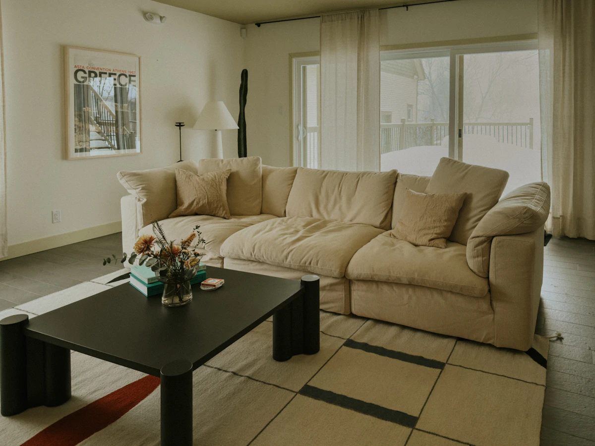 Deep, softly cushioned cream sofa in a bright living room