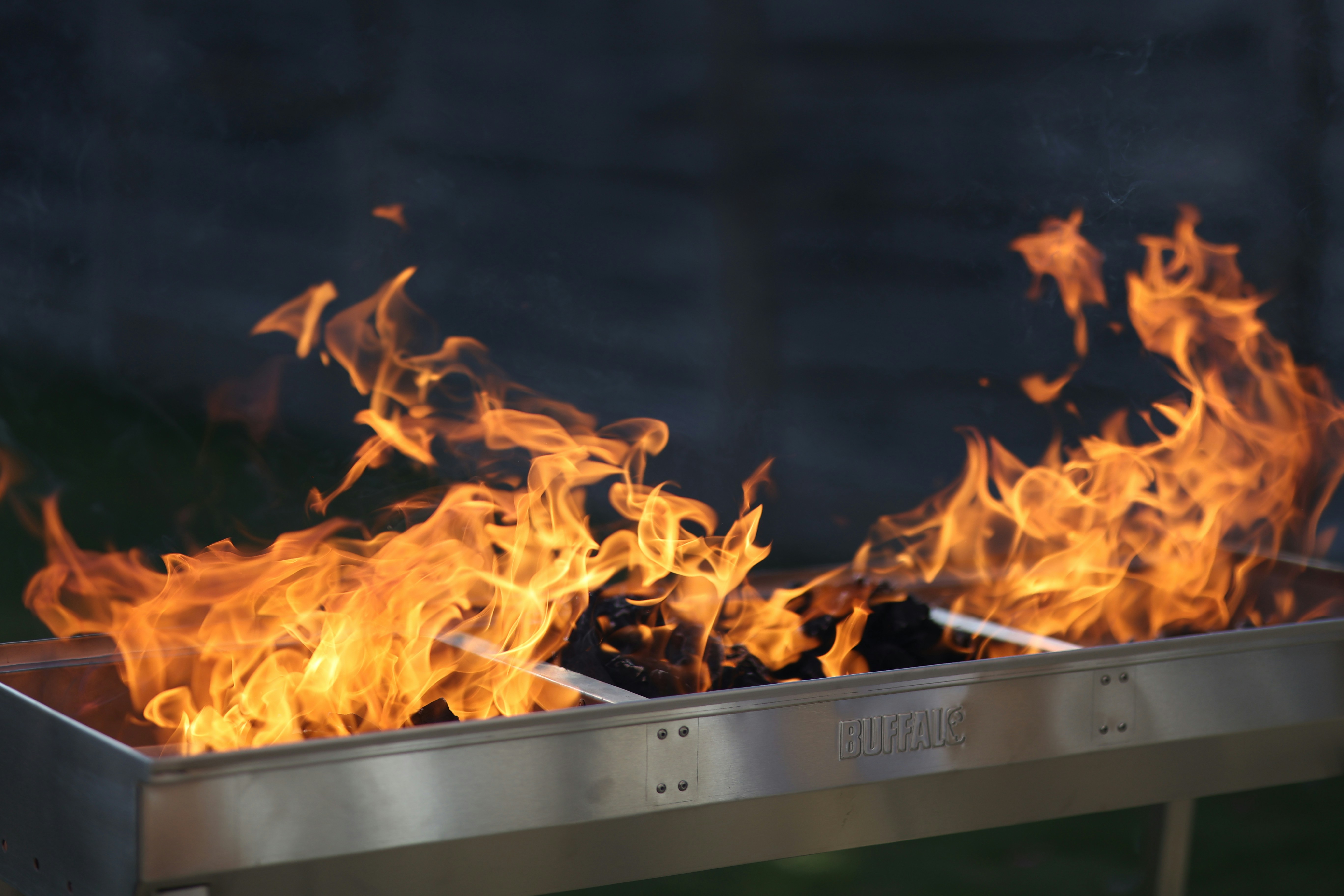 Flames leap from a grill, ready for cooking.