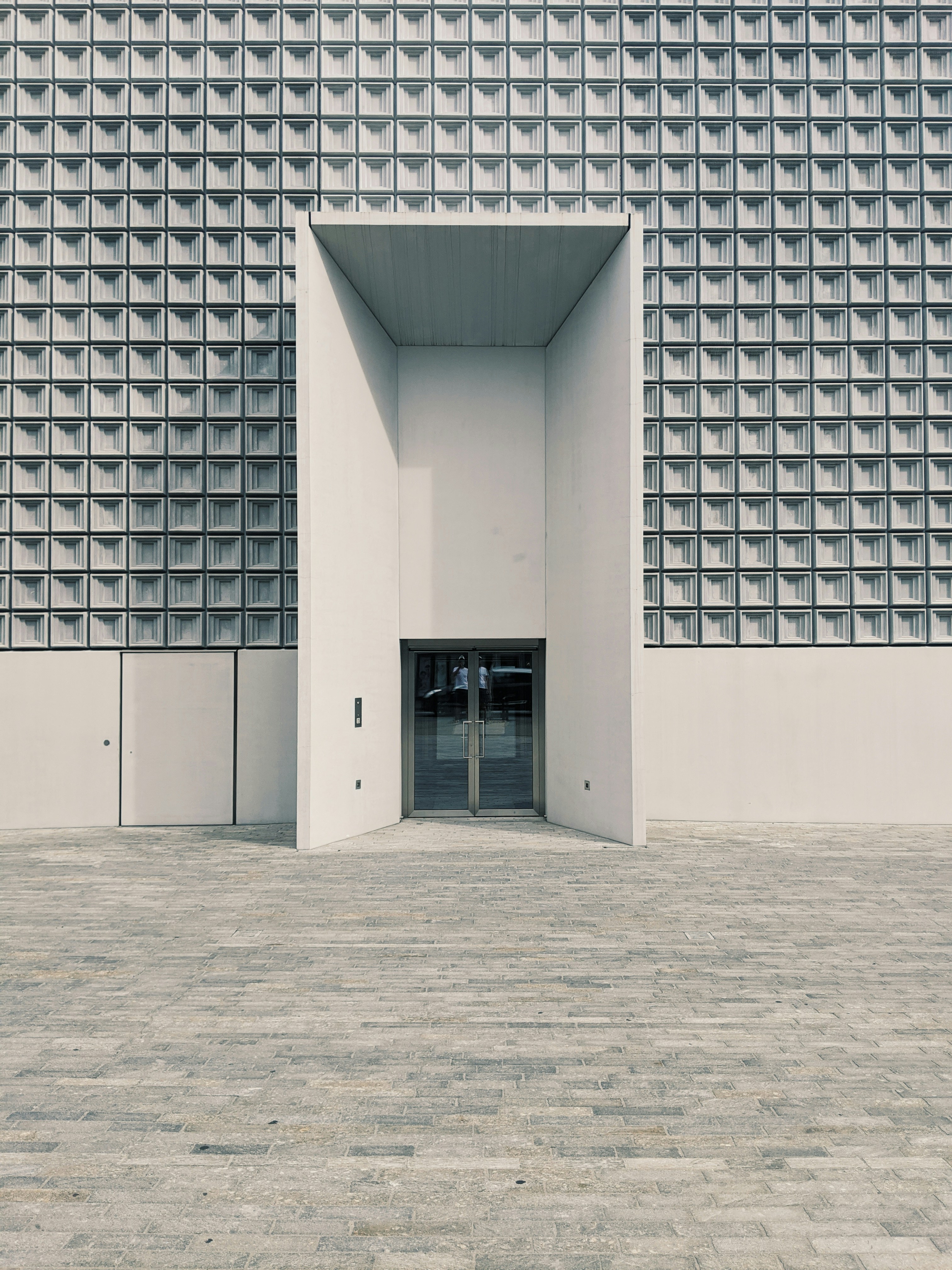Modern building with geometric patterned facade and doorway.
