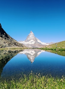 The matterhorn reflecting perfectly in the lake's blue water.