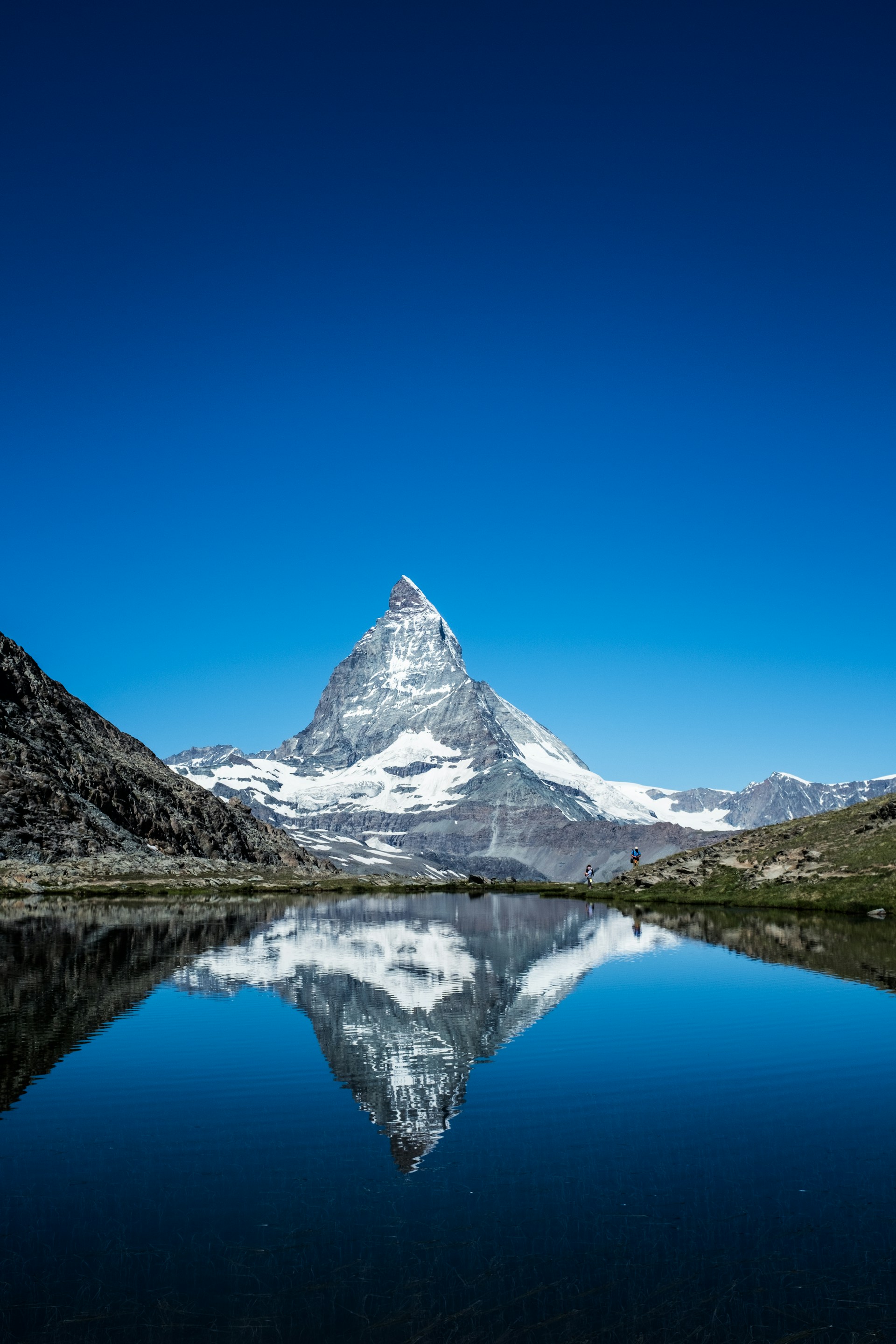 Matterhorn mountain reflected in serene lake water.