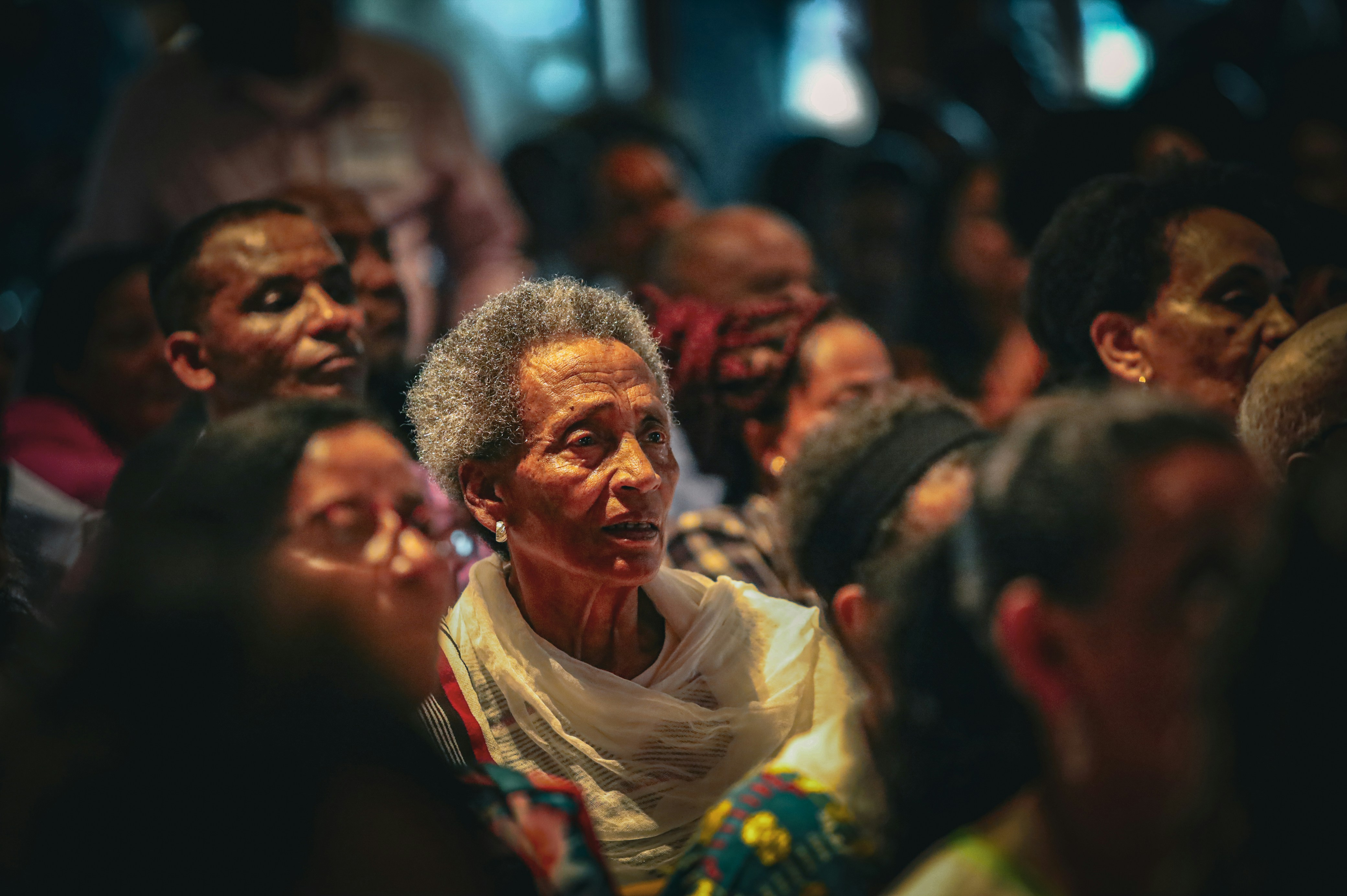 Audience members watching something on stage.