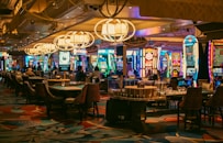 A casino interior with slots and tables is shown.