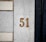 Number 51 is displayed on a stone wall.