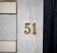 Number 51 is displayed on a stone wall.