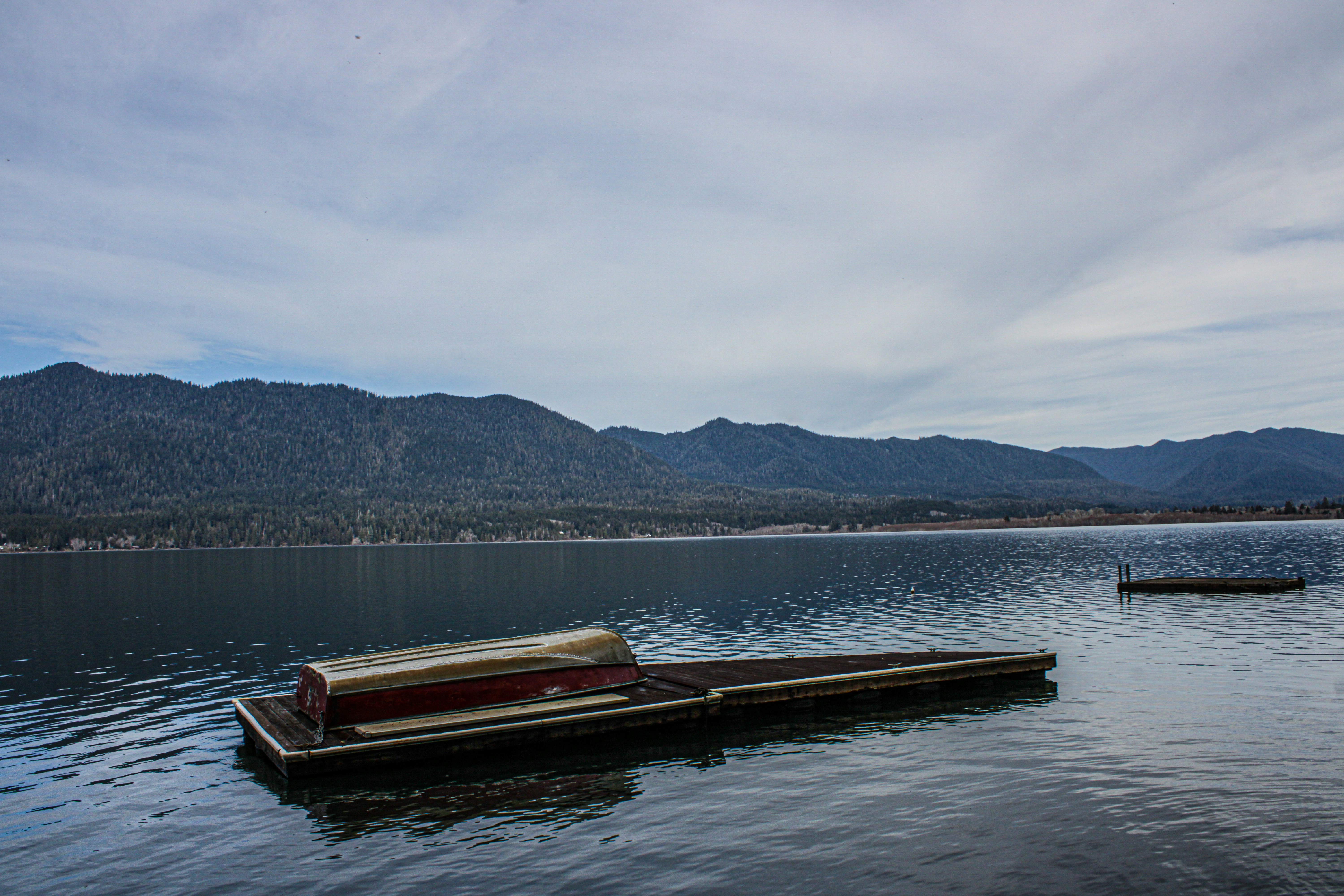 A tranquil lake with a floating dock anchored in place, demonstrating stability in a serene environment. - floating dock anchor
