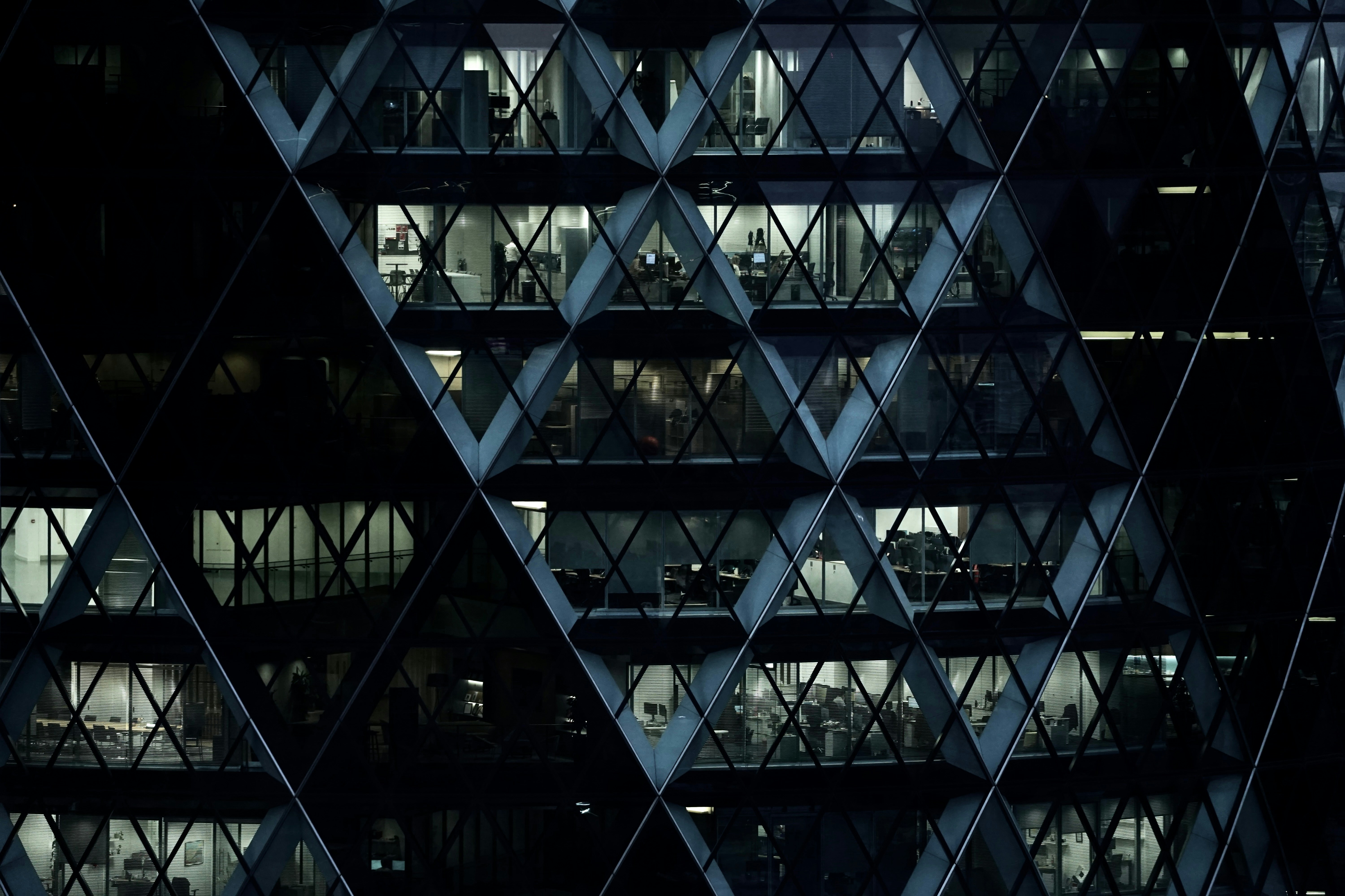 Modern office building lit up at night